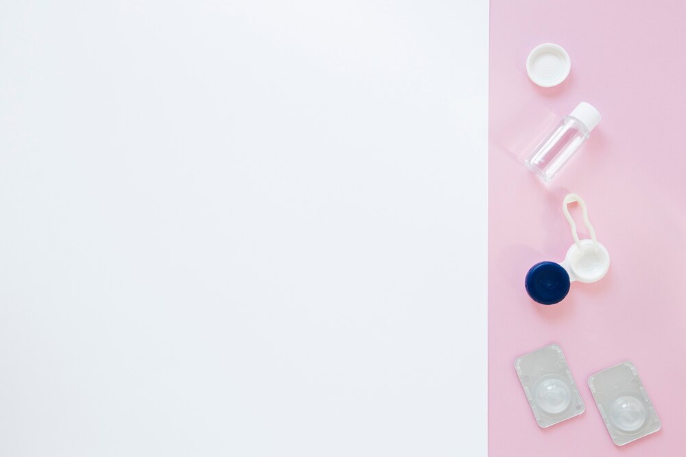 Eye care products on pink and white background